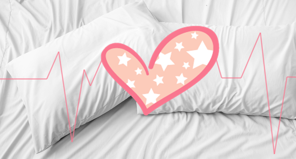 white pillows with a drawing of a heart and an ECG line on them